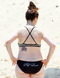 The back of singer Alanis Morissette's bikini bottom reads "Self Love." Credit: FameFlynet